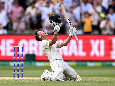 Australian batsman David Warner celebrates scoring his double century on the second day of the second Test against South Africa at the MCG in Melbourne.