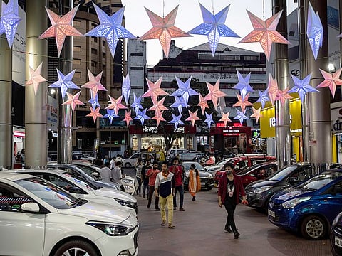 People arrive at a shopping mall in Kochi.