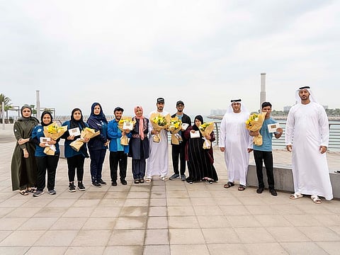 People of determination receive their free bus card from RAKTA officials