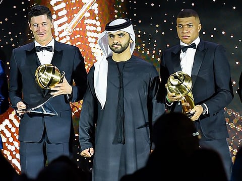 Kylian Mbappe and Robert Lewandowski with Sheikh Mansoor bin Mohammed bin Rashid Al Maktoum at the Dubai Globe Soccer Awards