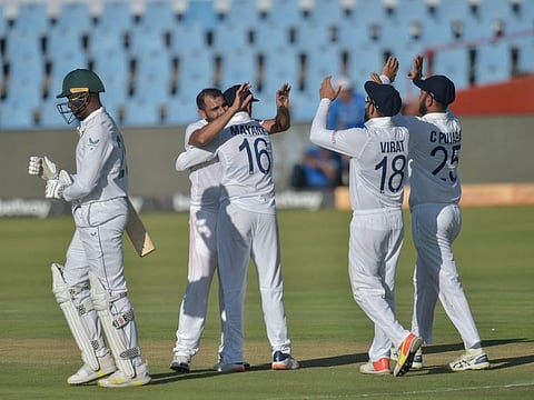 Indian pacer Mohammed Shami (second from left) celebrates the dismissal of South Africa's Kagiso Rabada (left), who is walking back to the pavilion, during the third day of the first Test against South Africa at Centurion on Tuesday.n December 28, 2021. (Photo by Christiaan Kotze / AFP)