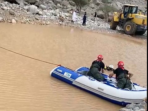 Ras Al Khaimah Police recovering the bodies of father and son who drowned in floodwater on Wednesday