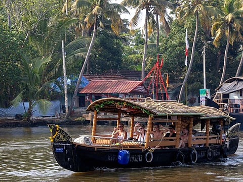 A traditional boat takes a group of western tourists on a cruise on the Alleppey backwaters in the southern state of Kerala.