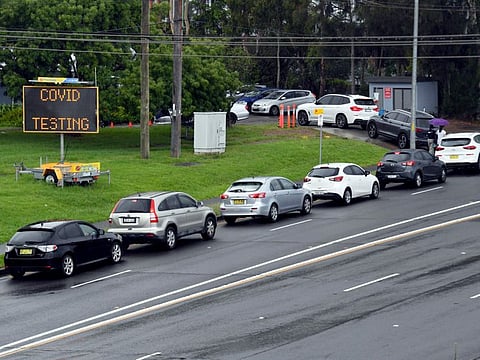 People line up in cars for COVID test at a clinic in Sydney on December 29, 2021.
