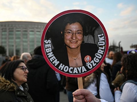 A protester holds a placard of Turkey's Medical Association President Sebnem Korur Fincanci, reading "We want freedom for Sebnem" on December 23, 2022, in front of Istanbul's courthouse.