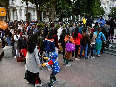 Passengers stand in queues to enter the Rajiv Chowk Metro Station as DMRC operates with 50% seating capacity and no standing passengers amid increasing Omicron cases, at Connaught Place, in New Delhi on Wednesday.