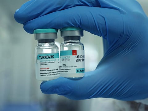 A Turkish Health Ministry official holds a vial of Turkovac, the country's first locally-developed COVID-19 vaccine, in Sanliurfa.