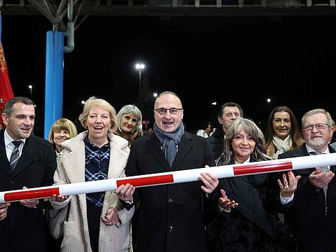Minister of Foreign and European Affairs Goran Grlic-Radman, center, raises the crossing gates at the border in Gorican, Croatia, Sunday, January 1, 2023