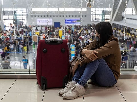 A passenger bound for a flight to Japan waits for her delayed flight at the Ninoy Aquino International Airport, in Pasay City, Metro Manila.