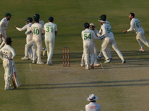 Pakistan's players celebrate after the dismissal of New Zealand's Henry Nicholls (not pictured) during the first day of the second cricket Test at the National Stadium in Karachi.