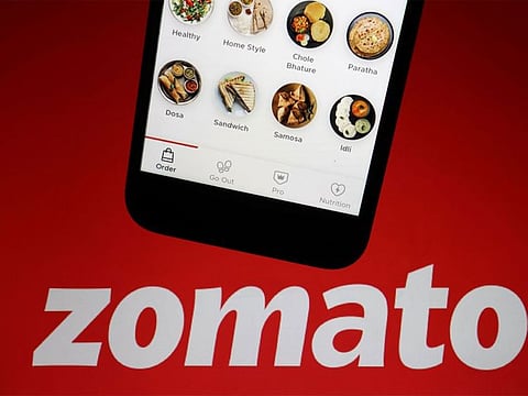 The app of Indian food delivery company Zomato is seen on a mobile phone above its logo displayed in this illustration picture taken July 14, 2021