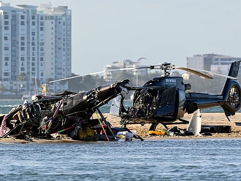 Two crashed helicopters sit on the sand at a collision scene near Seaworld, on the Gold Coast, Australia, Monday, Jan. 2, 2023.