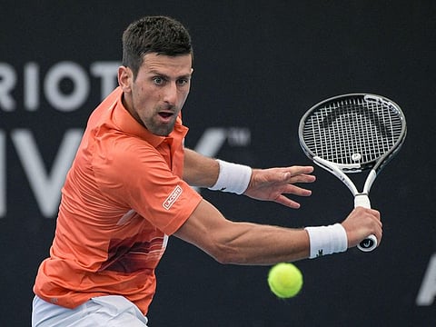 Serbian tennis player Novak Djokovic hits a return during his first round match against France's Constant Lestienne at the ATP Adelaide International tournament in Adelaide on January 3, 2023.