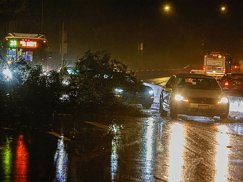 Traffic navigates around downed tree limbs along 19th Avenue after a new bout of rainstorms threatens to flood San Francisco, in California, on January 4, 2023.