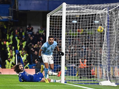 Manchester City's Algerian midfielder Riyad Mahrez celebrates scoring the opening goal during the English Premier League football match against Chelsea at Stamford Bridge in London on January 5, 2023.