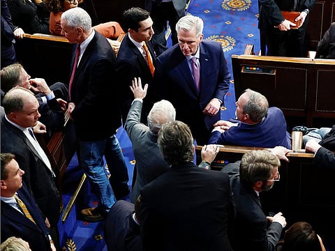 Rep. Patrick McHenry (R-NC) waves off House Republican Leader Kevin McCarthy and his Floor Director John Leganski at McCarthy's side after things became physical around Rep. Matt Gaetz (R-FL) and House Freedom Caucus members after Gaetz voted "present" rather than voting for McCarthy in a late night 14th round of voting for a new House Speaker on the fourth day of the 118th Congress at the US Capitol in Washington, on January 6, 2023.
