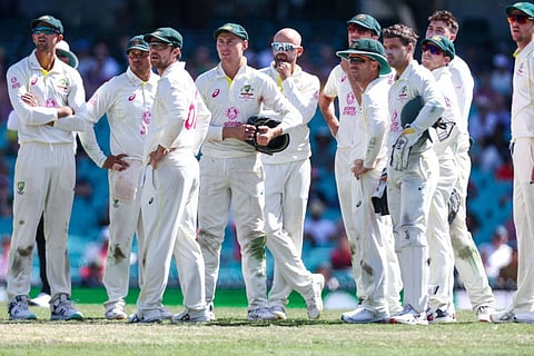 Australias Nathan Lyon (centre) reacts with team mates as they watch a replay for a catch by Steve Smith, which was given not out, during the third Test between Australia and South Africa at the Sydney Cricket Ground (SCG) in Sydney.