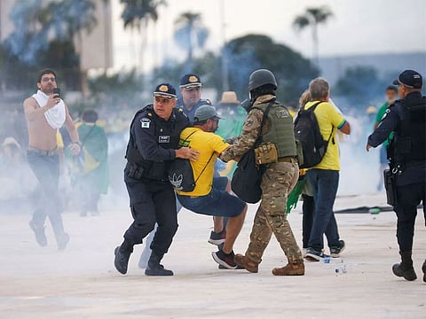 Security forces detain a supporter of Brazil's former President Jair Bolsonaro during a demonstration against President Luiz Inacio Lula da Silva, outside Brazil’s National Congress in Brasilia, Brazil, January 8, 2023