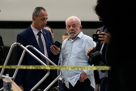 Brazil's President Luiz Inacio Lula da Silva walks in Planalto Palace after it was stormed by supporters of Brazil's former President Jair Bolsonaro in Brasilia, Brazil, Sunday, Jan. 8, 2023. (AP Photo/Eraldo Peres)