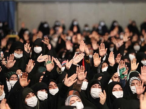 This handout picture provided by the office of Iran's Supreme Leader Ayatollah Ali Khamenei shows women waving as they attend his address in the capital Tehran on January 9, 2023.