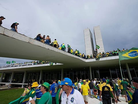 Protesters, supporters of Brazil's former President Jair Bolsonaro, storm the National Congress building in Brasilia, Brazil, Sunday, Jan. 8, 2023.