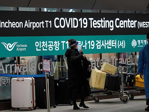 A woman arriving from China enters a COVID-19 testing center at the Incheon International Airport In Incheon, South Korea, Thursday, Jan. 5, 2023.
