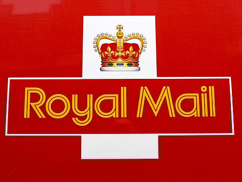 A Royal Mail sign is pictured on a delivery van outside a Post Office, in St Albans, Britain.
