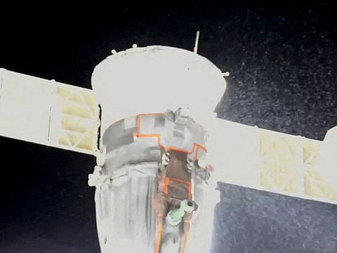 A stream of particles sprays out of the Soyuz spacecraft on the International Space Station.