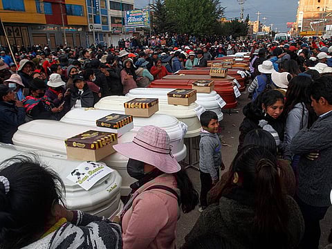 Relatives of 18 people killed in clashes with security forces wait with empty coffins outside the morgue of the Carlos Monge Medrano hospital in Juliaca, southern Peru.
