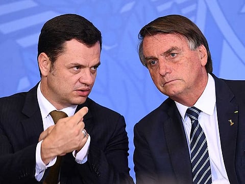 In this file photo taken on June 27, 2022, Brazilian President Jair Bolsonaro (L) and his Minister of Justice Anderson Torres talk during an event to present the new national ID and passport at Planalto Palace in Brasilia.