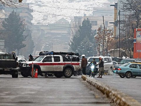 Taliban security forces block a road after a suicide blast near Afghanistan's foreign ministry at the Zanbaq Square in Kabul on January 11, 2023.