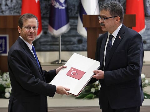Turkey's ambassador to Israel Sakir Ozkan Torunlar (right), presents his credentials to Israeli President Isaac Herzog, in Jerusalem, on January 11, 2023.