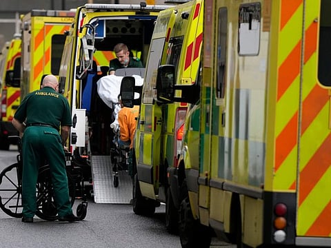 A patient is taken in to an ambulance as other ambulances wait outside the Royal London Hospital in east London, Wednesday, Jan. 4, 2023.