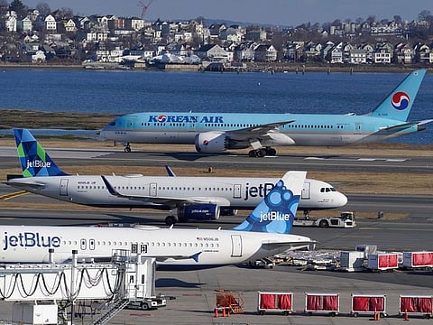 Passenger jets are seen on the tarmac at Logan International Airport, Jan. 11, 2023, in Boston. Thousands of flight delays and cancellations rippled across the U.S. early Wednesday after computer outage led to a grounding order by the Federal Aviation Administration