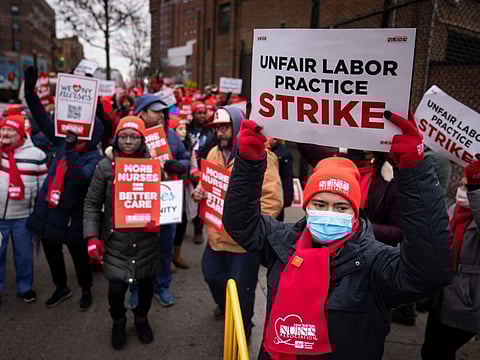 Protestors march on the streets around Montefiore Medical Centre during a nursing strike, Wednesday, Jan. 11, 2023, in the Bronx borough of New York.