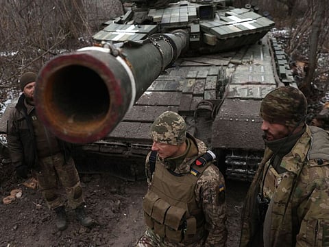 Ukrainian servicemen stand near a tank on the frontline near Kreminna, Lugansk region, on January 12, 2023.