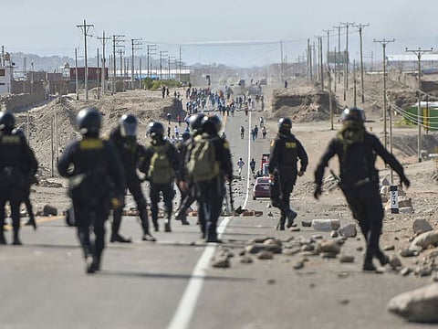 Policemen patrol the Pan-American highway at La Joya as demonstrators hold a blockade to demand the resignation of Peruvian President Dina Boluarte in Arequipa, Peru