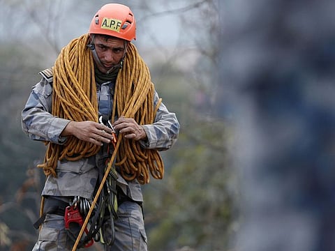 A member of Arm Police Force works at a crash site of a Yeti Airlines operated aircraft, in Pokhara, Nepal.