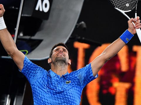 Serbia's Novak Djokovic celebrates after winning against Spain's Roberto Carballes Baena during their men's singles match on day two of the Australian Open tennis tournament in Melbourne.