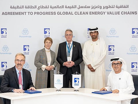 Adnoc's Musabbeh Al Kaabi and thyssenkrupp Uhde's Cord Landsmann sign the agreement.