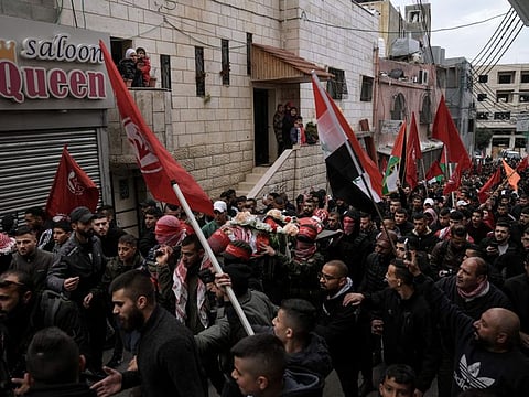 Mourners carry the body of 14-year-old Palestinian Omar Khumour during his funeral in the West Bank city of Bethlehem, on January 16, 2023. Costantini’s arrest came as Israeli troops raided the village in which the boy was also killed.