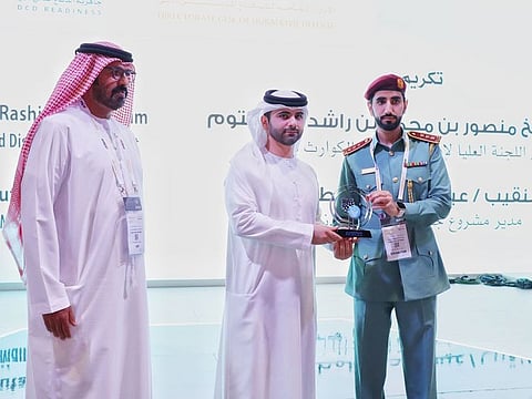 Sheikh Mansoor bin Mohammed bin Rashid Al Maktoum (centre) honoured Captain Issa Ahmed Al Mutawa (right), director of the Supervision Department at the General Directorate of Civil Defense in Dubai, in the presence of Lieutenant General Expert Rashid Thani Al Matroushi (left), Director-General of Dubai Civil Defence, at Intersec on Tuesday