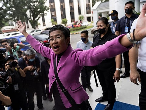 Rappler CEO and Nobel Laureate Maria Ressa gestures after a Manila court acquitted her from a tax evasion case, outside the Court of Tax Appeals in Quezon City, Philippines.