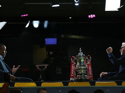 BBC TV pundits and former players Paul Ince (left) and Gary Lineker pictured with the FA Cup trophy at the Molineux Stadium, Wolverhampton, Britain.