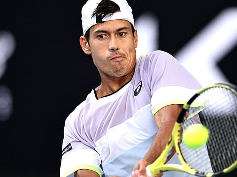 Australia's Jason Kubler hits a return against Russia's Karen Khachanov in a rally that lasted 70 shots.