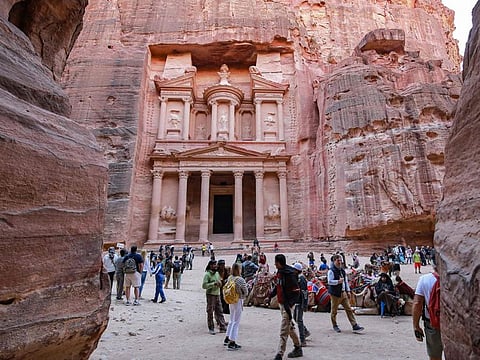 Visitors tour near the Treasury at the ruins of the ancient Nabatean city of Petra in southern Jordan.