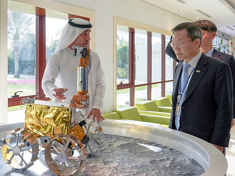 Salem AlMarri (left) showing a replica of Rashid Rover to Lee Jong-ho