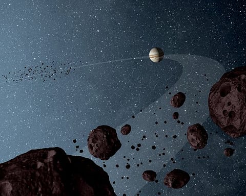 New results from NASA's Wide-field Infrared Explorer, or WISE, reveal that the Jovian Trojans - asteroids that lap the sun in the same orbit as Jupiter - are uniformly dark with a hint of burgundy, and have matte surfaces that reflect little sunlight. The results are illustrated in this artist's concept, showing both the leading and trailing packs of Trojans in orbit with Jupiter.