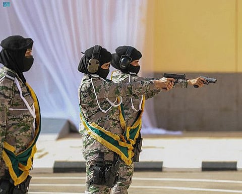 Saudi female soldiers show skills at graduation ceremony.