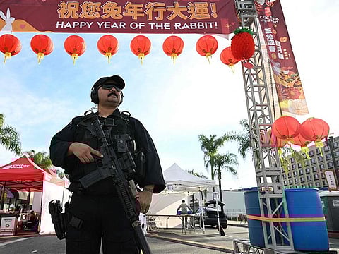 Monterey Park police officers stand at the scene of a mass shooting in Monterey Park, California.